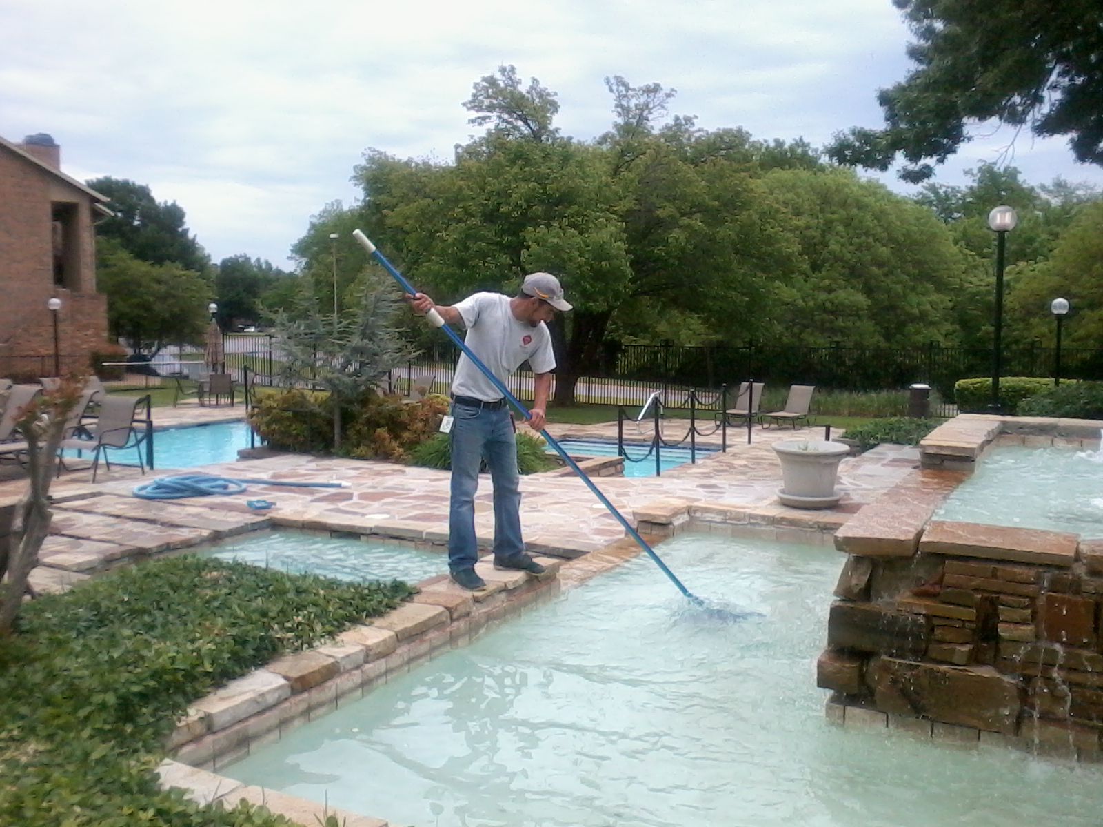 Man Cleaning A Pool